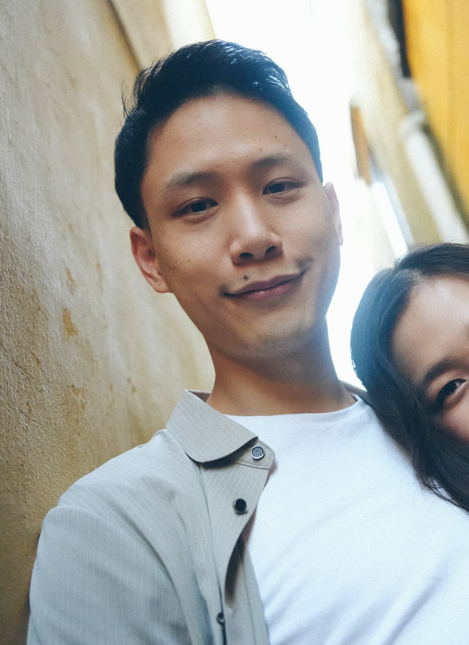 Smiling couple leaning together in an alley