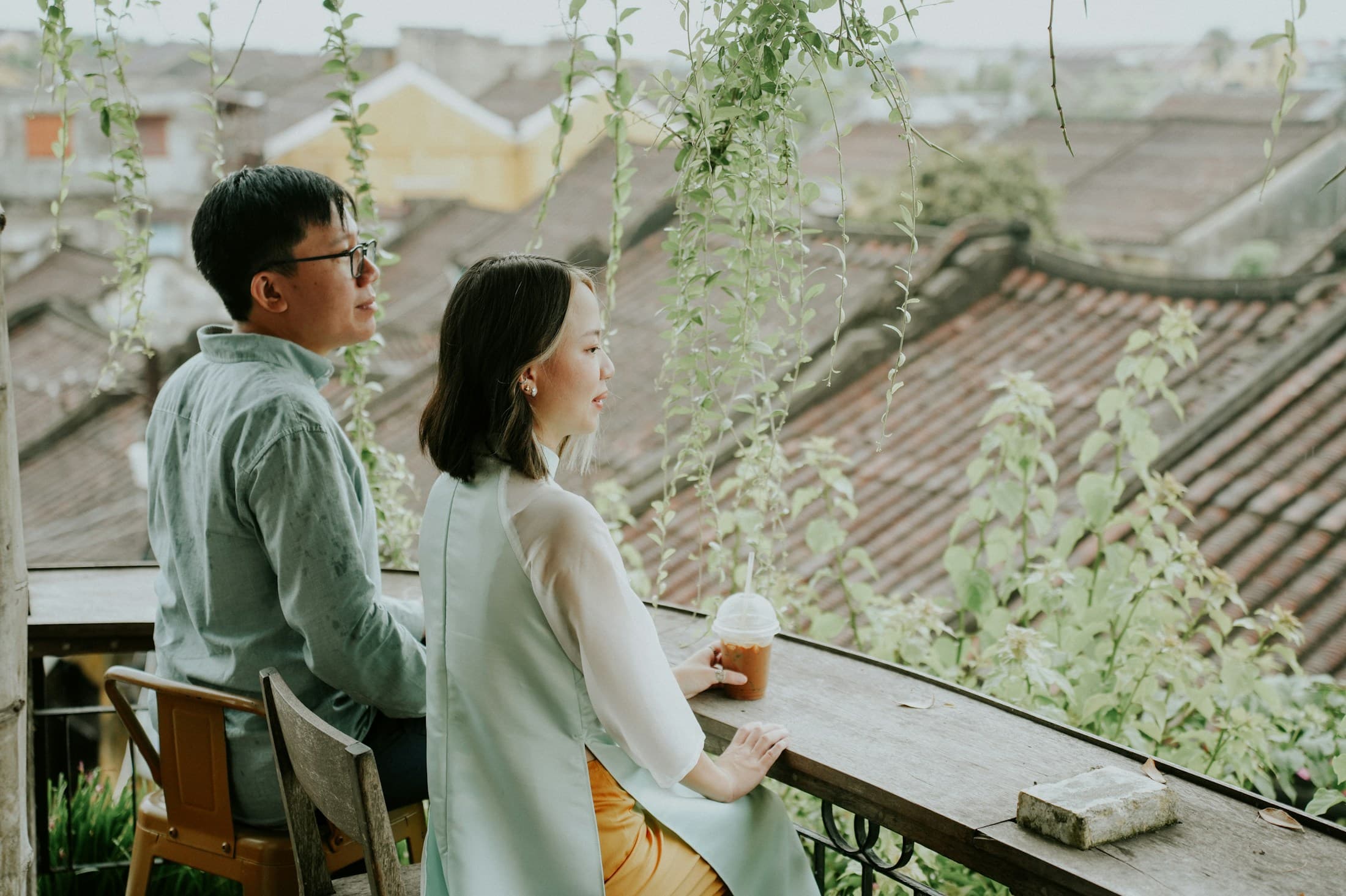 Couple sharing drinks above city rooftops