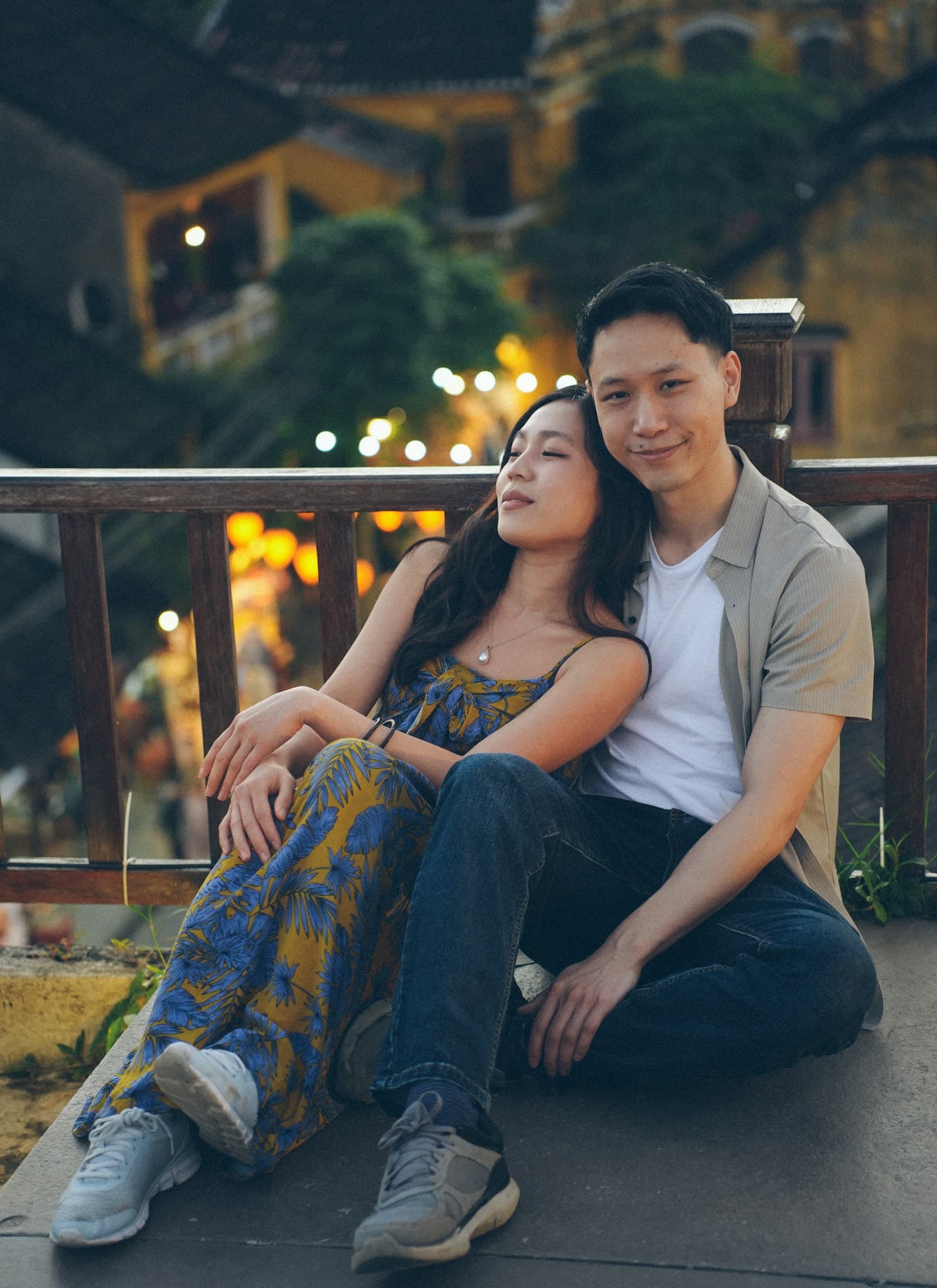 Couple sitting together at dusk with city lights