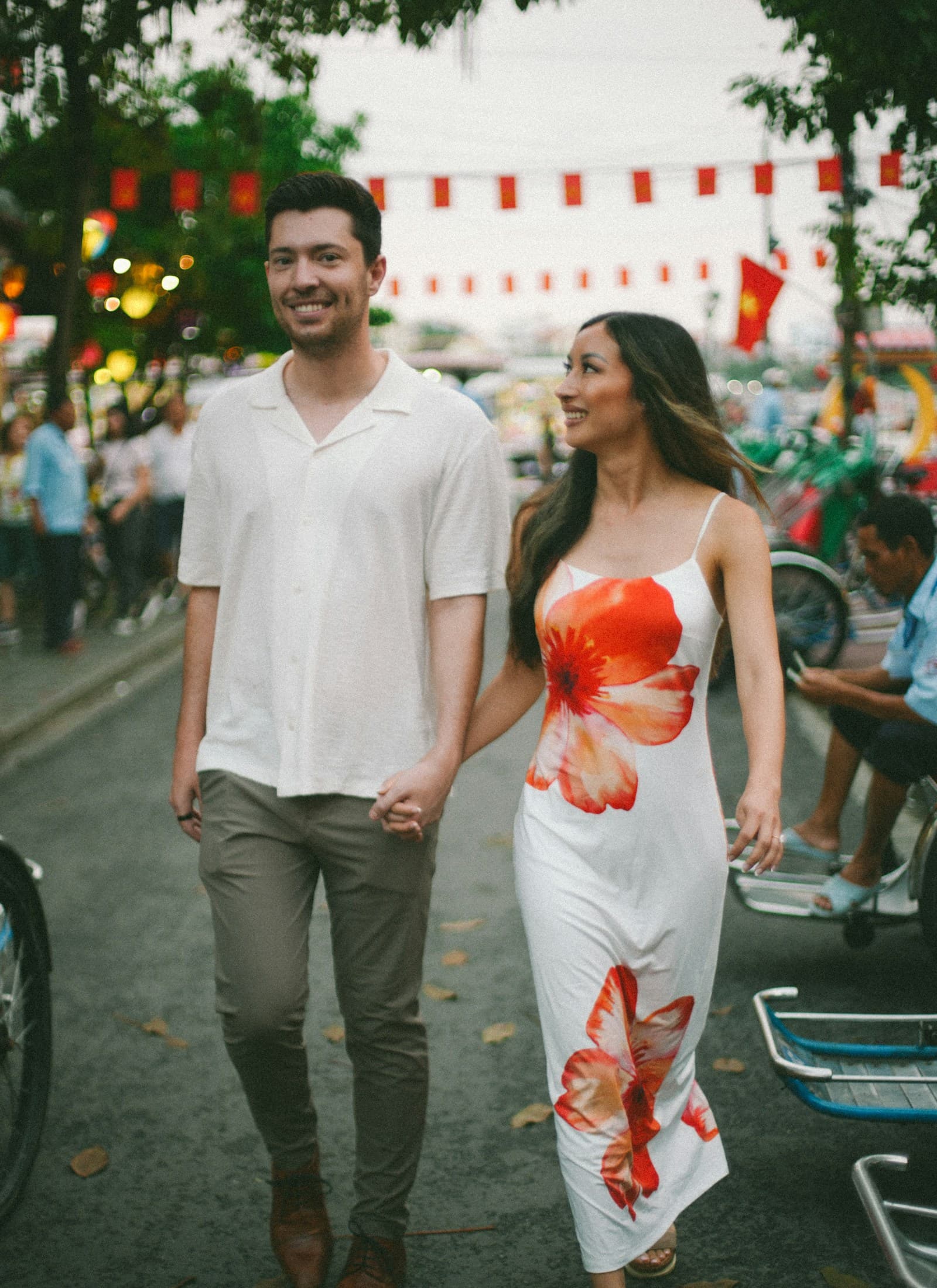 Couple walking hand in hand down a city street